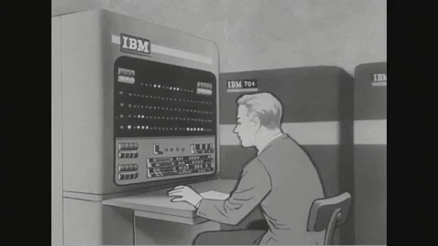 A guy sitting at an IBM mainframe.